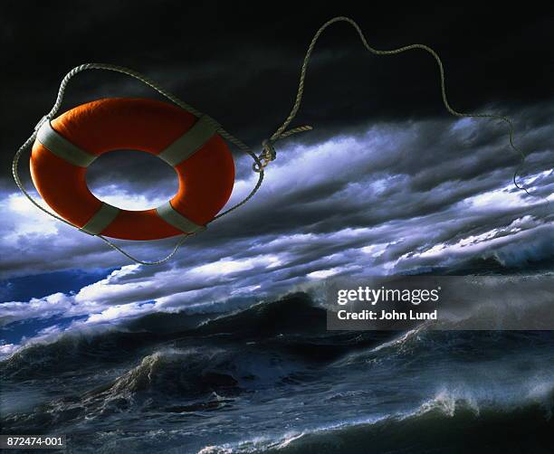 life ring over rough sea (digital composite) - rettungsring stock-fotos und bilder