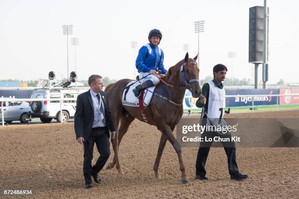 Jockey Dane O'Neill riding Manark wins the Dubai Kahayla Classic during the Dubai World Cup race day at the Meydan racecourse on March 28, 2015 in...