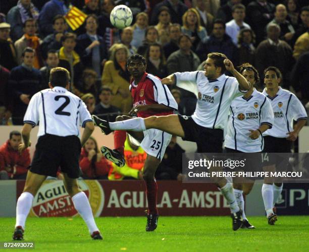 Kanu of Arsenal vies with Pellegrino , Baraja, Zahovic and Vicente of Valencia CF in a Champions' League quarer final 17 April 2001 in Valencia.