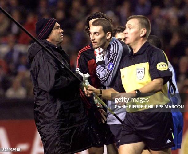 British referee Poll Graham removes a plastic rod that hit Christian Abbiati of AC Milan during the Champions League Group B match between Deportivo...