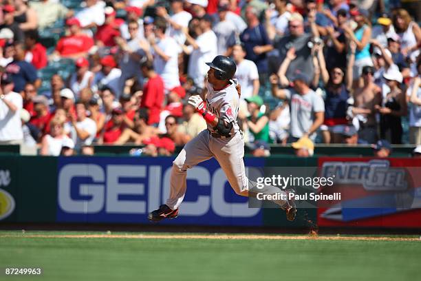 Julio Lugo of the Boston Red Sox runs to second base after hitting a leadoff double in the top of the 10th inning during the game against the Los...