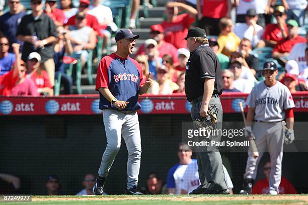 Manager Terry Francona of the Boston Red Sox argues with home plate umpire Bill Miller after getting thrown out of the game against the Los Angeles...