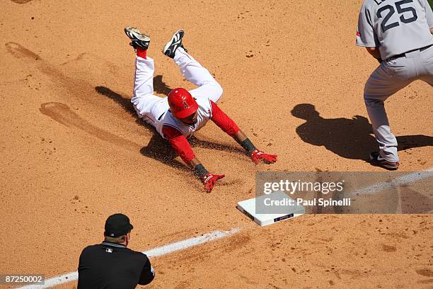 Erick Aybar of the Los Angeles Angels of Anaheim slides into third base while hitting a triple with one out in the bottom of the seventh inning...