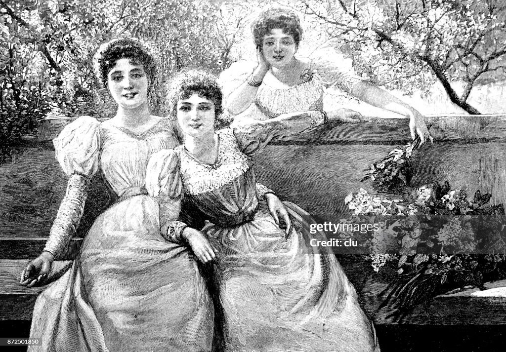 Three young women on the bench having fun