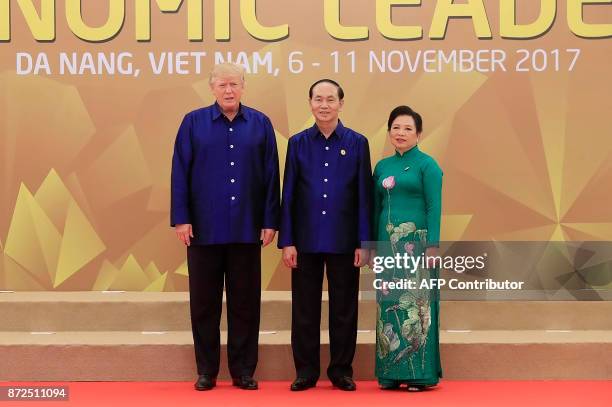 President Donald Trump poses with Vietnams President Tran Dai Quang as his wife Nguy?n Th? Hi?n upon arrival for the Asia-Pacific Economic...