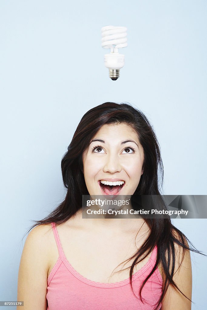 Woman having idea with lightbulb