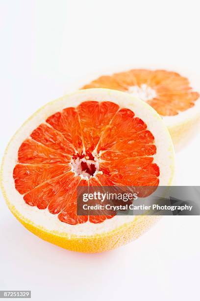 sliced grapefruit - half and half stock pictures, royalty-free photos & images