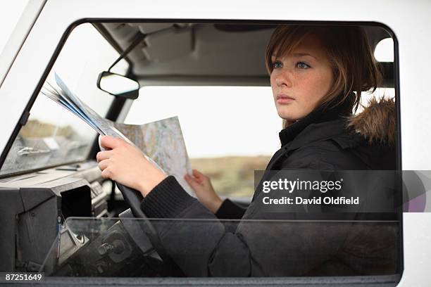 woman in car with map - david oldfield stock pictures, royalty-free photos & images