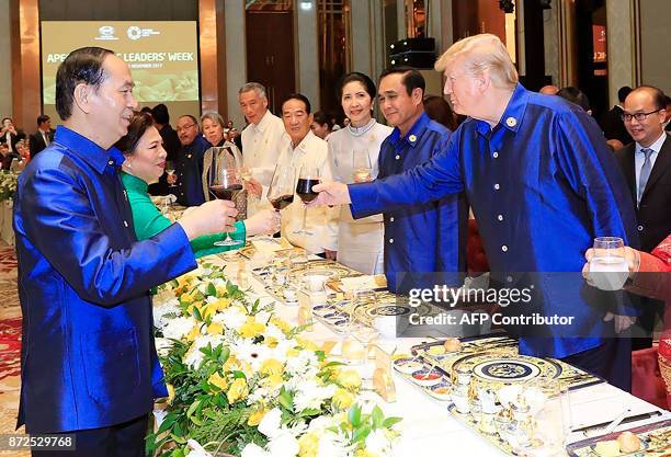 Vietnams President Tran Dai Quang makes a toast with US President Donald Trump at the start of the Asia-Pacific Economic Cooperation Summit leaders...