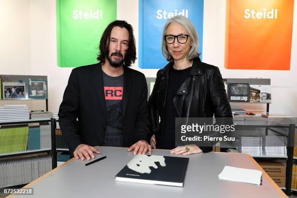Actor Keanu Reeves and Artist Alexandra Grant are seen posing by their book "Ode to happiness" during "Paris Photo" at le Grand Palais on November...