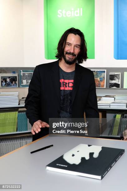 Actor Keanu Reeves is seen posing by his book "Ode to happiness" during "Paris Photo" at le Grand Palais on November 10, 2017 in Paris, France.