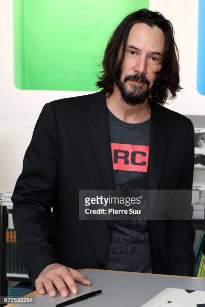 Actor Keanu Reeves is seen posing by his book "Ode to happiness" during "Paris Photo" at le Grand Palais on November 10, 2017 in Paris, France.