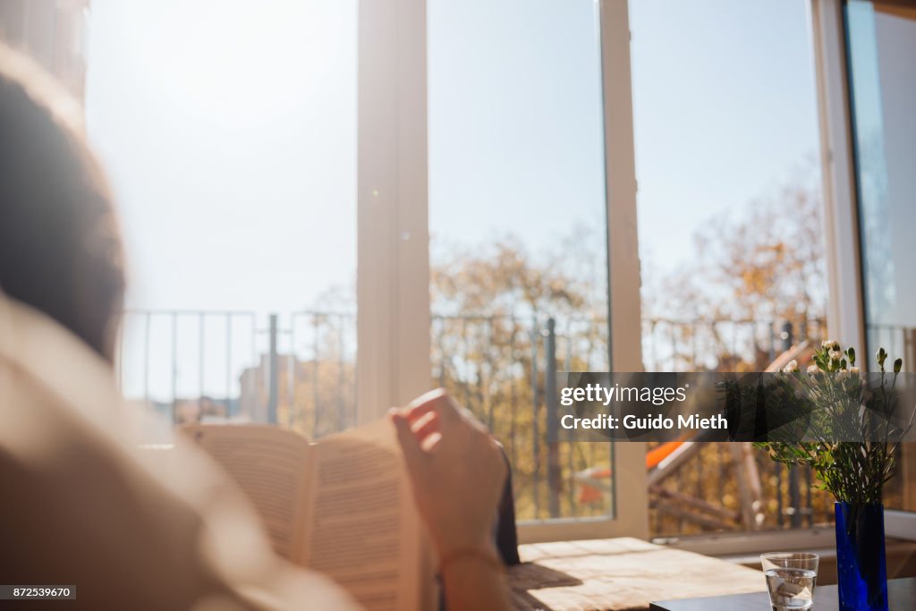 Woman reading in sunlight.