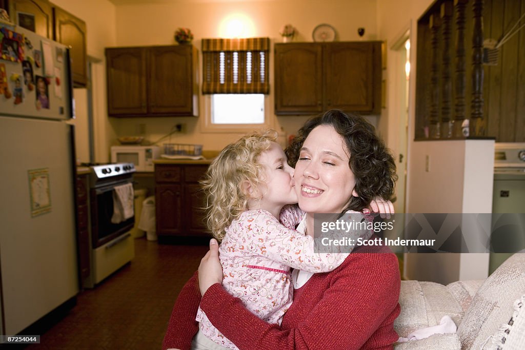 Daughter kissing mother's cheek