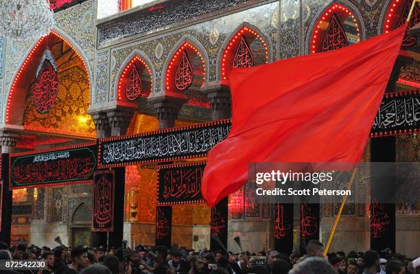 Shiite pilgrims flagellate themselves with chains and was a red flag as they reach the climax of days of marching inside the shrine of Imam Hossein...