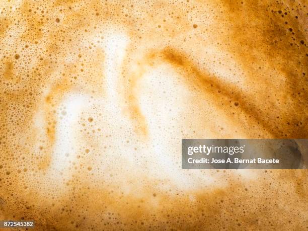 full frame of a cup of freshly made coffee with milk, backgrounds. - chocolate swirls stock-fotos und bilder