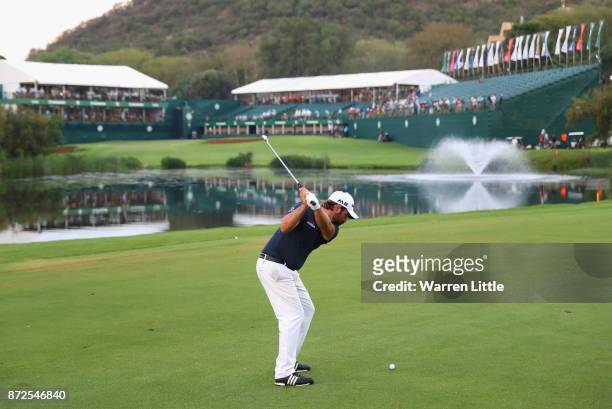 Victor Dubuisson of France plays his second shot into the 18th green during the second round of the Nedbank Golf Challenge at Gary Player CC on...