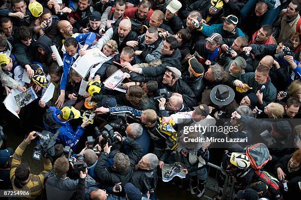 Valentino Rossi of Italy and Fiat Yamaha Team signs autographs for fans during the pit walk during the practice day in the MotoGP of France on May...