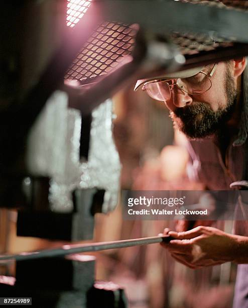 iron worker making curtain rod in metal shop - カーテンレール ストックフォトと画像