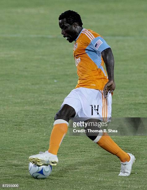 Ade Akinbiyi of the Houston Dynamo handles the ball against FC Dallas at Robertson Stadium on May 9, 2009 in Houston, Texas.