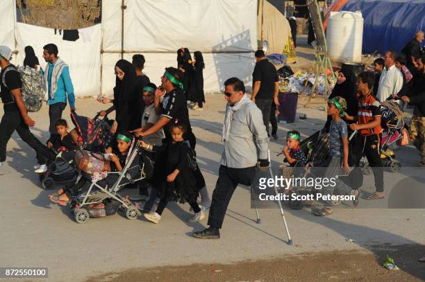Columns of Shiite pilgrims, including babies in strollers and a man with one leg, march 50 miles from Najaf north to the shrine of Imam Hossein to...
