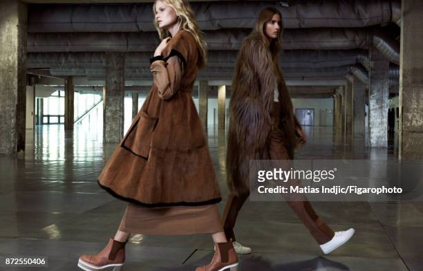 Models Estee Rammant and Nathalia O pose at a fashion shoot for Madame Figaro on September 19, 2017 in Paris, France. Left: Coat and dress , boots ....