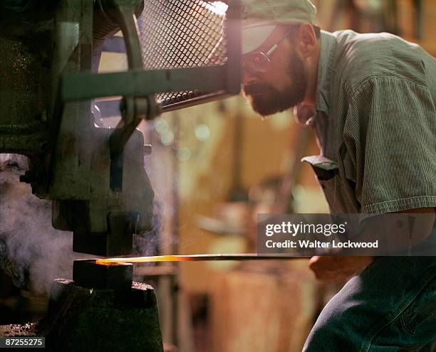 iron worker making curtain rod in metal shop - カーテンレール ストックフォトと画像