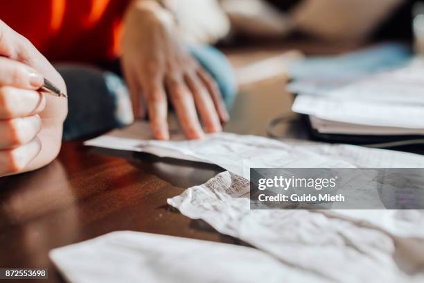 womans hand, ball pen and receipt. - northern european descent stock pictures, royalty-free photos & images