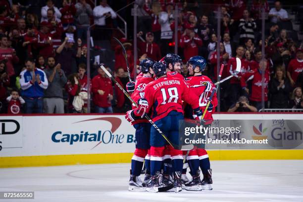 Taylor Chorney of the Washington Capitals celebrates with his teammates after scoring a first period goal against the New York Islanders at Capital...