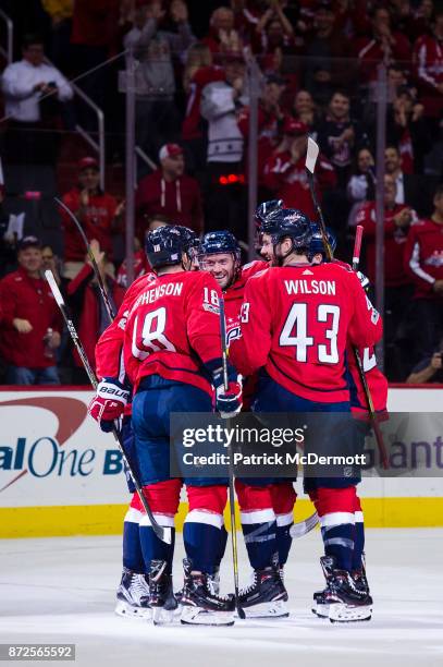 Taylor Chorney of the Washington Capitals celebrates with his teammates after scoring a first period goal against the New York Islanders at Capital...