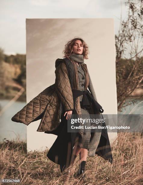 Model Klaudia K poses at a fashion shoot for Madame Figaro on September 12, 2017 in Paris, France. Outer parka , inner parka , suit and scarf ,...