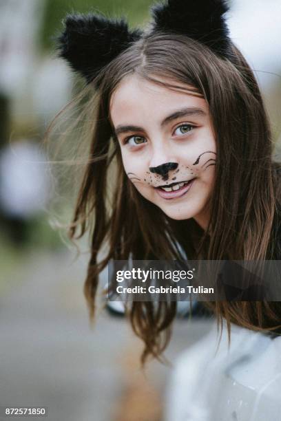 girl in a cat's costume at halloween - cat costume stock pictures, royalty-free photos & images