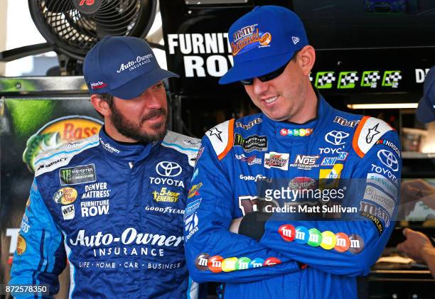 Martin Truex Jr., driver aof the Auto-Owners Insurance Toyota, and Kyle Busch, driver of the M&M's Caramel Toyota, talk during practice for the...