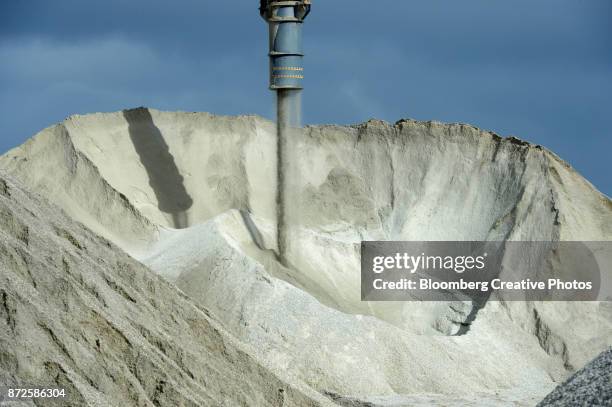 lithium ore falls from a chute onto a stockpile - lithium mining stock pictures, royalty-free photos & images