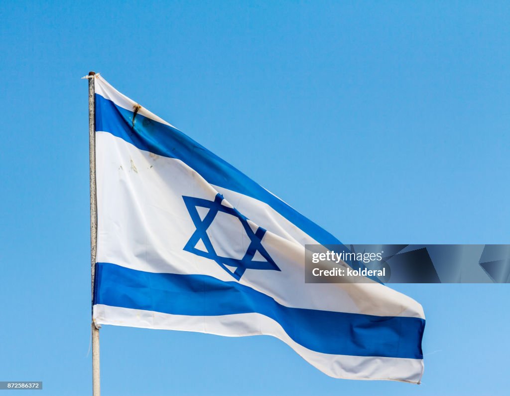 National Flag of Israel against blue sky