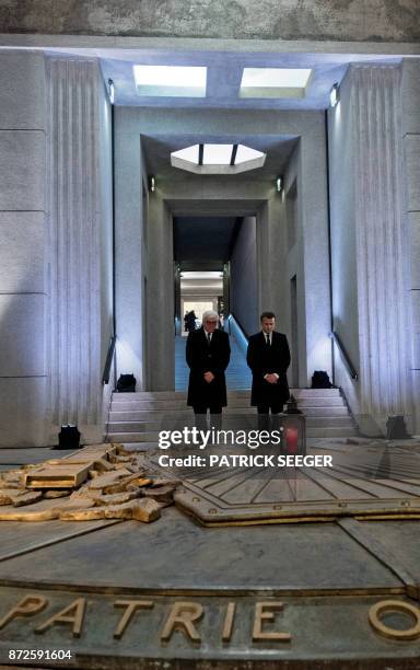French President Emmanuel Macron and German President Frank-Walter Steinmeier bow their heads as they attend the inauguration of the WWI...