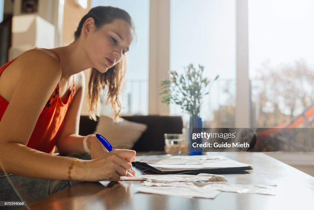 Woman doing bookkeeping at home.