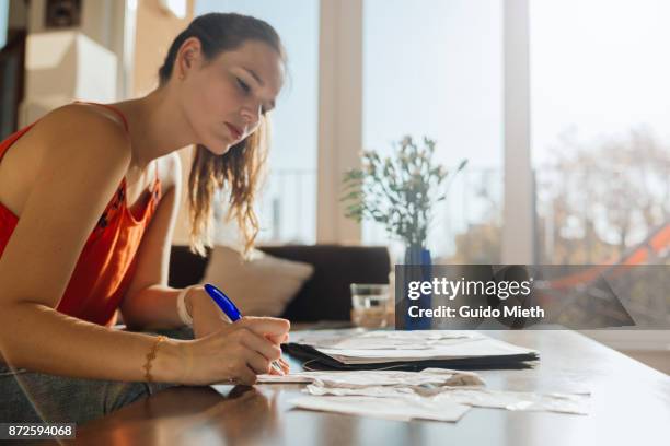 woman doing bookkeeping at home. - bookkeeping stock pictures, royalty-free photos & images