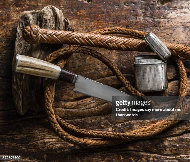 gaucho knife, whip, silver cigarette case on wood. still life - animal macho 個照片及圖片檔