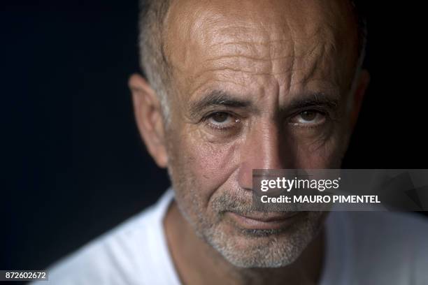 Construction worker Jose Luis Farias da Silva whose son was a victim of stray bullets fired by a police officer, poses for a portrait after an...