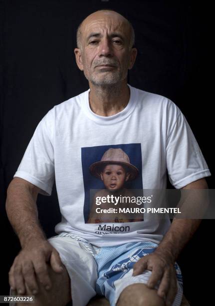 Construction worker Jose Luis Farias da Silva whose son was a victim of stray bullets fired by a police officer, poses for a portrait after an...