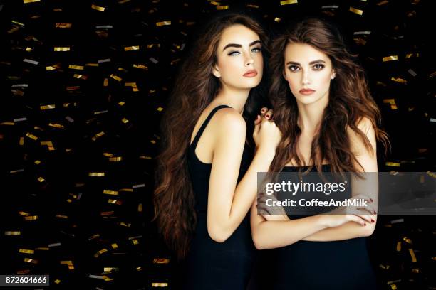 two beautiful women - black dress party stock pictures, royalty-free photos & images