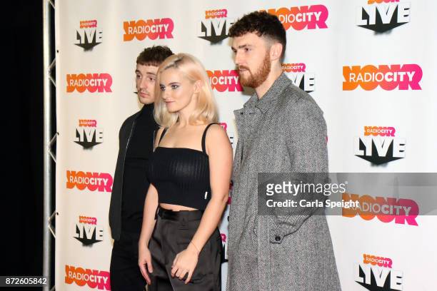 Grace Chatto, Jack Patterson and Luke Patterson of Clean Bandit pose before performing during Radio City Live held at Echo Arena on November 10, 2017...
