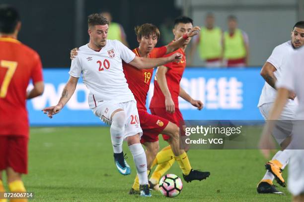 Yin Hongbo of China and Sergej Milinkovic-Savic of Serbia compete for the ball during International Friendly Football Match between China and Serbia...