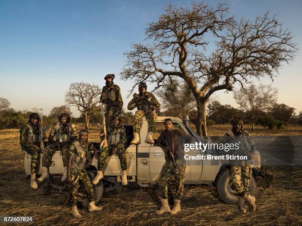 Zakouma Rangers "Mamba Team 1" seen with their vehicle inside the park at the end of a patrol. Driver Issa Idriss Adoum, wearing the brown shirt,...