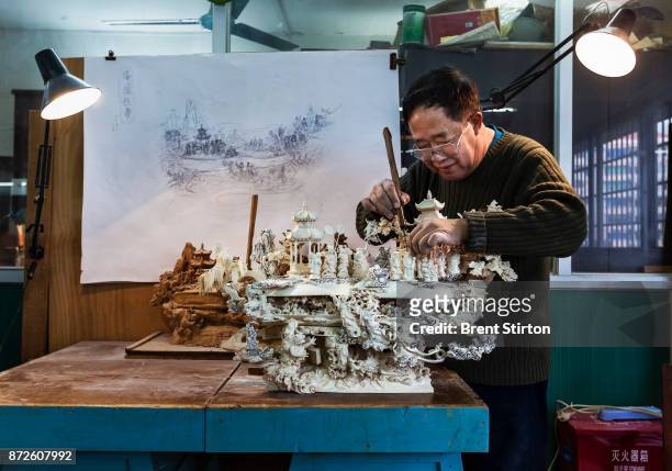 The majority of ivory makes its way to China, by far the largest consumer on earth. In this image ivory carver Wu Rong Chang who has been carving for...