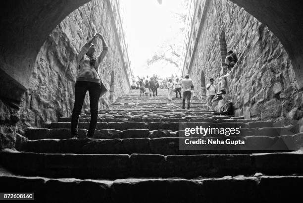 agrasen ki baoli - a young tourist - agrasen ki baoli stock pictures, royalty-free photos & images