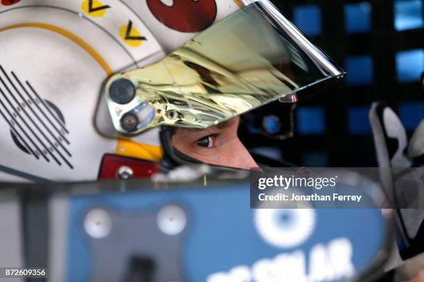 Brennan Poole, driver of the DC Solar Chevrolet, sits in his car during practice for the NASCAR XFINITY series Ticket Galaxy 200 at Phoenix...