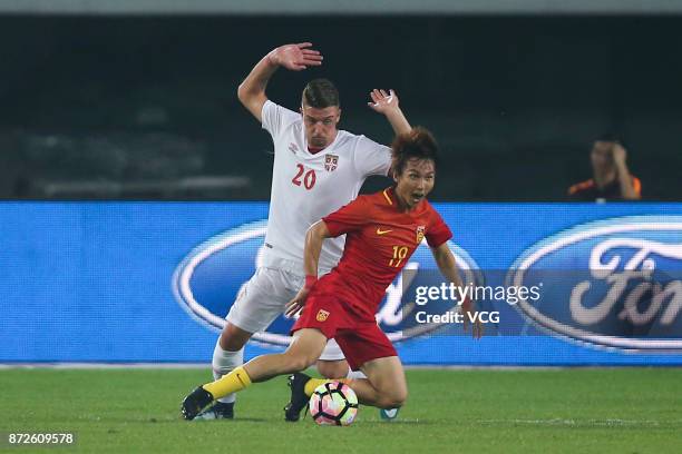 Yin Hongbo of China and Sergej Milinkovic-Savic of Serbia compete for the ball during International Friendly Football Match between China and Serbia...