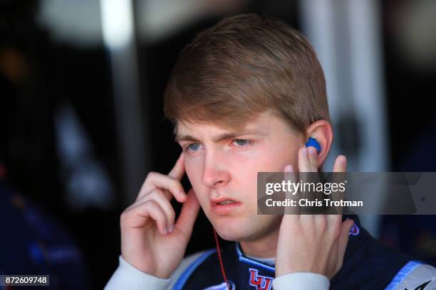 William Byron, driver of the Liberty University Chevrolet, stands in the garage during practice for the NASCAR XFINITY series Ticket Galaxy 200 at...